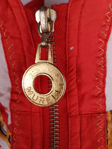 Closeup view of embossed zipper tag of a Vintage 1980s - 1990s Mureli silk bomber jacket 