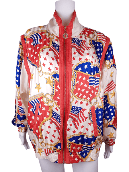 Full front view of a Vintage 1980s - 1990s  Mureli silk bomber jacket with a red, white, blue and gold USA flag and chain print, detachable sleeves, red trim and an oversized blouson silhouette, displayed on a mannequin
