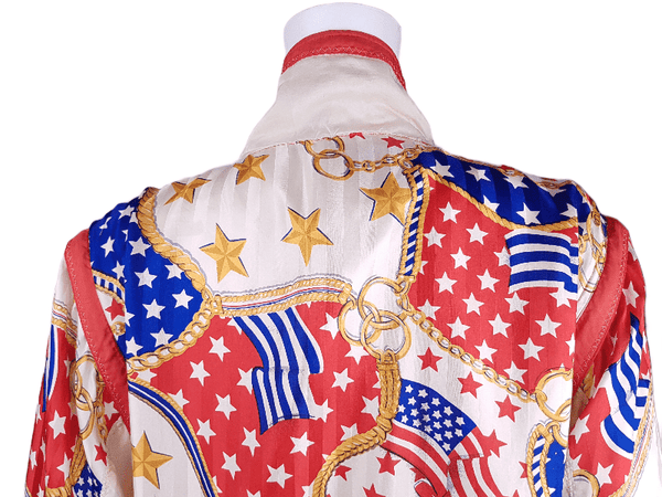 Closeup view of back shoulder and collar on a Vintage 1980s - 1990s  Mureli silk bomber jacket with a red, white, blue and gold USA flag and chain print, detachable sleeves, red trim and an oversized blouson silhouette, displayed on a mannequin