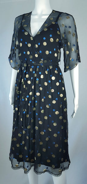 Full three quarter view of a Vintage 1980s Edith Strauss Black Silk Metallic Polka-Dot Midi Dress displayed on a mannequin