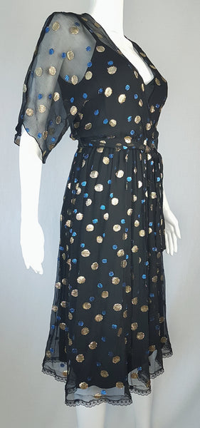 Full three quarter view of a Vintage 1980s Edith Strauss Black Silk Metallic Polka-Dot Midi Dress displayed on a mannequin