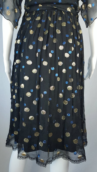 Back hemline and skirt view of a Vintage 1980s Edith Strauss Black Silk Metallic Polka-Dot Midi Dress displayed on a mannequin