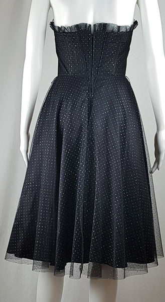 Full back view of a vintage 1980's Gunne Sax black formal dress with multicolor glitter dots, a pleated tulle sweetheart neckline and fitted bodice and full sweep skirt with a built-in crinoline displayed on a mannequin