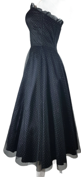 Full side view of a vintage 1980's Gunne Sax black formal dress with multicolor glitter dots, a pleated tulle sweetheart neckline and fitted bodice and full sweep skirt with a built-in crinoline displayed on a mannequin