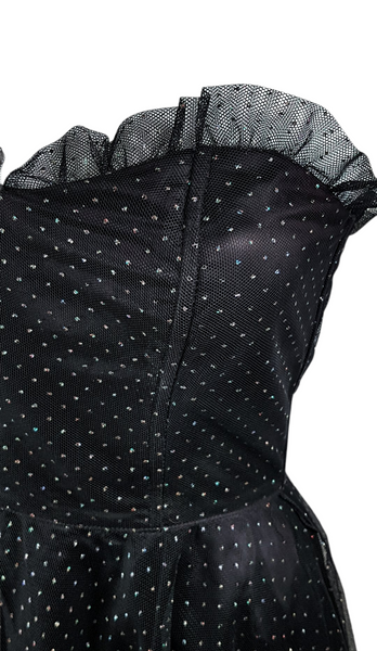 Closeup bodice view of a vintage 1980's Gunne Sax black formal dress with multicolor glitter dots, a pleated tulle sweetheart neckline and fitted bodice and full sweep skirt with a built-in crinoline displayed on a mannequin