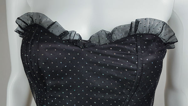 Closeup neckline view of a vintage 1980's Gunne Sax black formal dress with multicolor glitter dot overlay and a pleated tulle sweetheart neckline