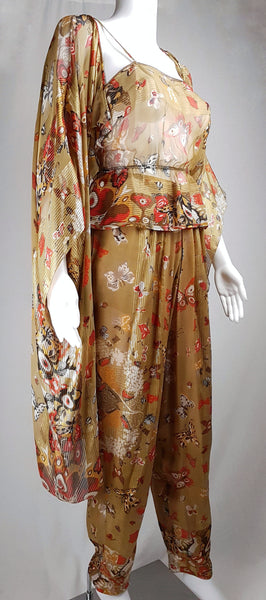 Three-quarter view of a vintage 1980s Soo Yung Lee gold metallic silk three-piece set with a draped kaftan, camisole and tapered trousers displayed on a mannequin