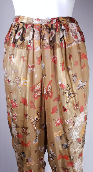 Closeup front view of vintage 1980s Soo Yung Lee gold metallic silk trousers with a fitted waistband and gathered hips 