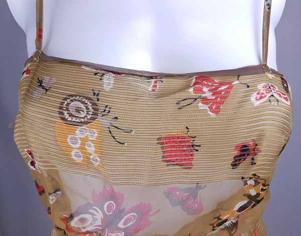 Closeup front view of a vintage 1980s Soo Yung Lee silk camisole with narrow straps, a straight neckline and a short flared peplum hem.