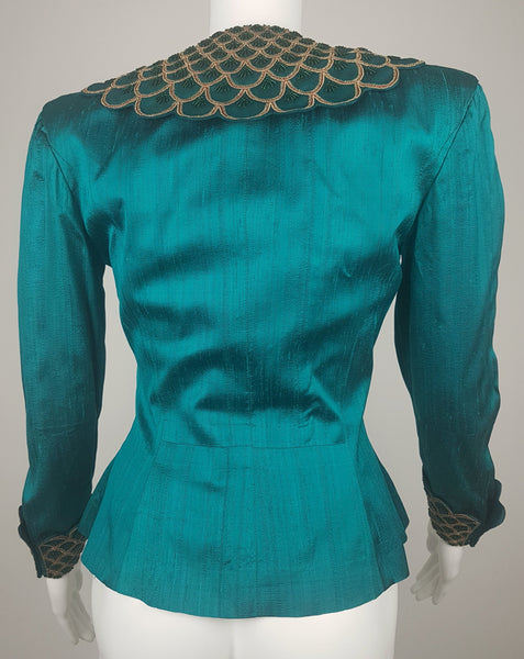 Full back mannequin view of a vintage 1980s Spaghetti London teal silk evening jacket with a beaded statement collar and deep embellished cuffs.