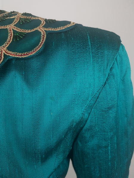 Condition close-up of the upper back and right shoulder showing a faint residual mark within the textured teal silk.