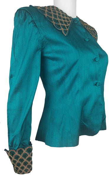 Three-quarter front view of a vintage 1980s Spaghetti London teal silk evening jacket with a beaded statement collar and deep embellished cuffs.