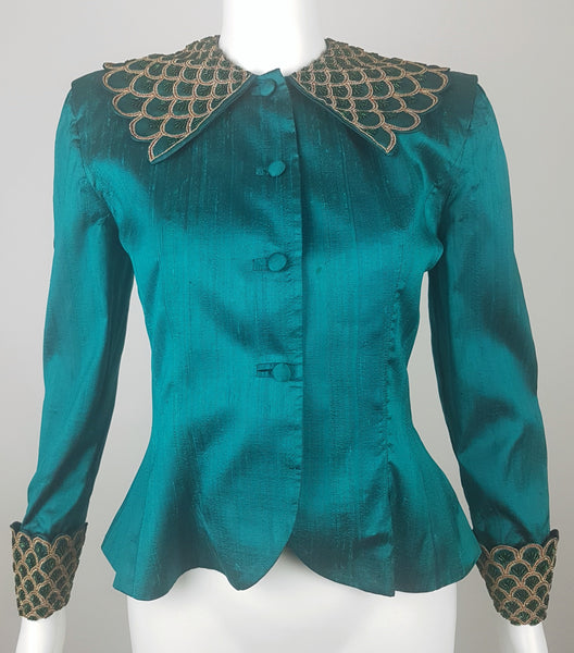 Full front mannequin view of a vintage 1980s Spaghetti London teal silk evening jacket with a beaded statement collar and deep embellished cuffs.