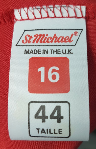 Brand and sizing label view of buttons on a vintage 1980s St Michael red pussy-bow blouse with stitched front pleats, fabric-covered buttons and gathered long sleeves 