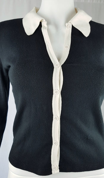  Close up front view of the vintage 1990s Agnès b. fitted black cotton cardigan top with long sleeves and a contrasting white collar displayed on a mannequin