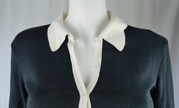  Close up collar and shoulder view of the vintage 1990s Agnès b. fitted black cotton cardigan top with long sleeves and a contrasting white collar displayed on a mannequin