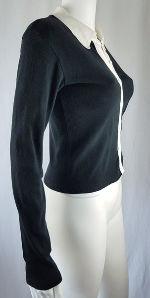  three quarter view of the vintage 1990s Agnès b. fitted black cotton cardigan top with long sleeves and a contrasting white collar displayed on a mannequin