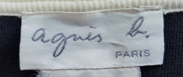 Close-up of the Agnès b. Paris label inside a vintage 1990s black-and-white cotton cardigan top