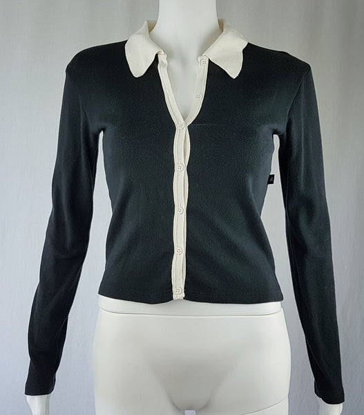  Full front view of the vintage 1990s Agnès b. fitted black cotton cardigan top with long sleeves and a contrasting white collar displayed on a mannequin