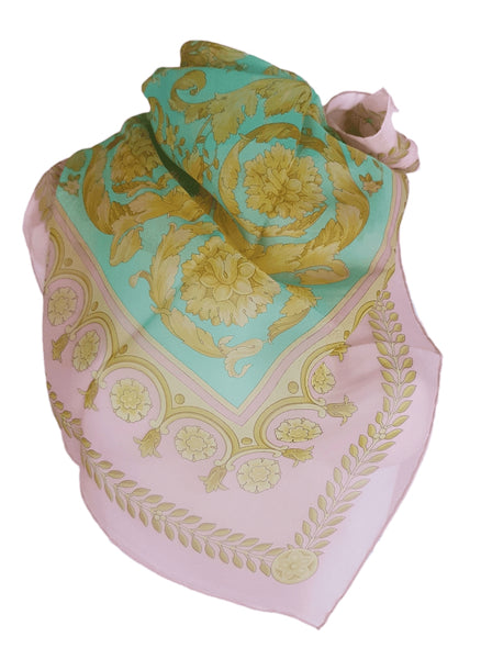 Vintage 1990s Atelier Versace silk scarf styled around a dress form, showing its aqua centre, pink border and ornate floral design.