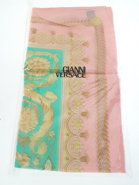 Deadstock 1990s Atelier Versace pastel pink and aqua silk scarf preserved in its original clear sleeve packaging.