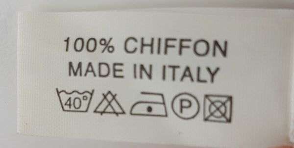 Close-up of the material label on a vintage 1990s Gianni Versace Profumi ivory chiffon scarf.