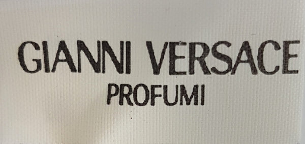 Close-up of the brand label on a vintage 1990s Gianni Versace Profumi ivory chiffon scarf.