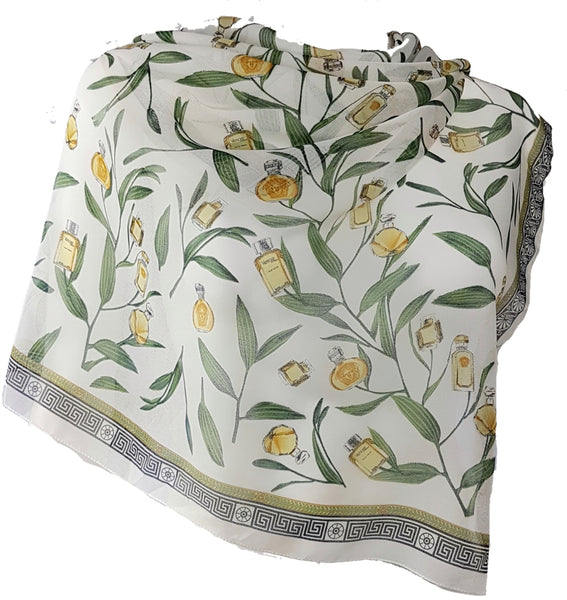 Large vintage 1990s Gianni Versace Profumi square scarf spread across a dress form, with green branches, gold perfume bottles and a black border.