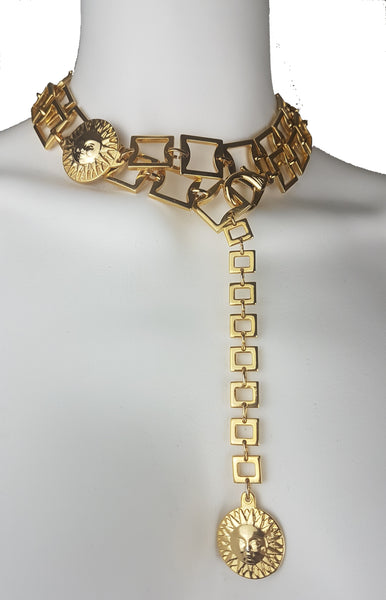 Gold-tone sun medallion belt styled as a statement necklace  displayed on a mannequin with the linked chain suspended down the front