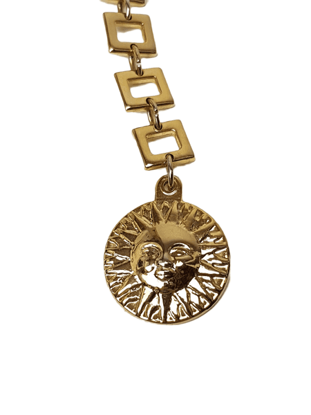Front of a raised sun-face medallion suspended from three graduated rectangular links