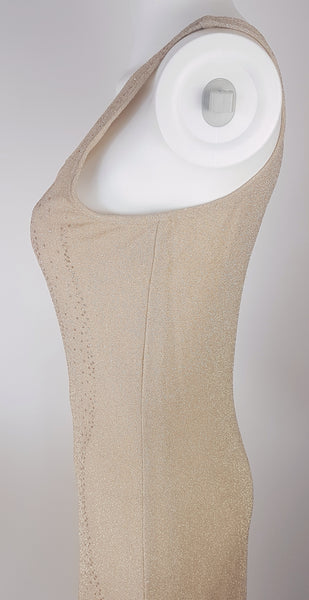Closeup side view of a vintage 1990s LA Glo gold lurex evening gown, showing its one-shoulder neckline 