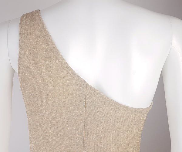 Closeup back view of a vintage 1990s LA Glo gold lurex evening gown, showing its one-shoulder neckline
