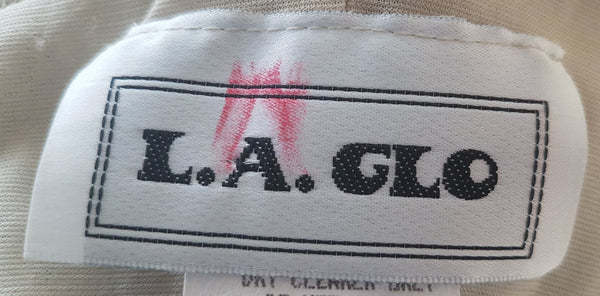 Label view of a vintage 1990s LA Glo champagne-gold lurex one-shoulder evening gown 