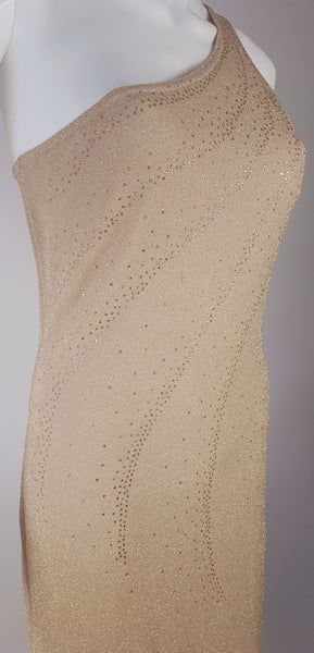 Three-quarter view of the fitted bodice on a vintage 1990s LA Glo one-shoulder gown with curved lines of gold glitter dots.