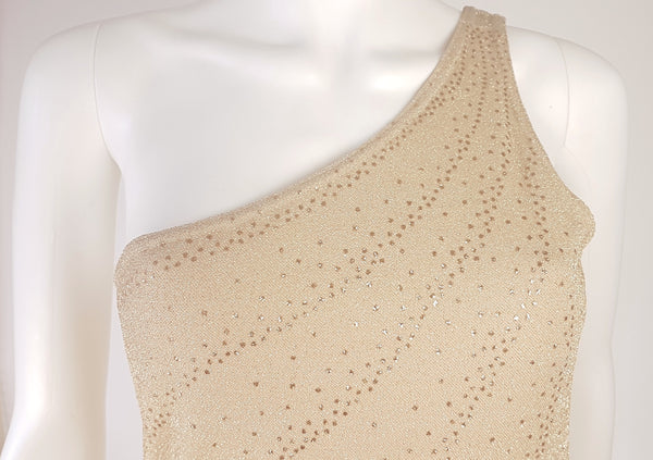 Detailed close-up of the shimmering gold lurex knit,  fitted bodice, and metallic glitter-dot detailing on a vintage 1990s LA Glo dress.
