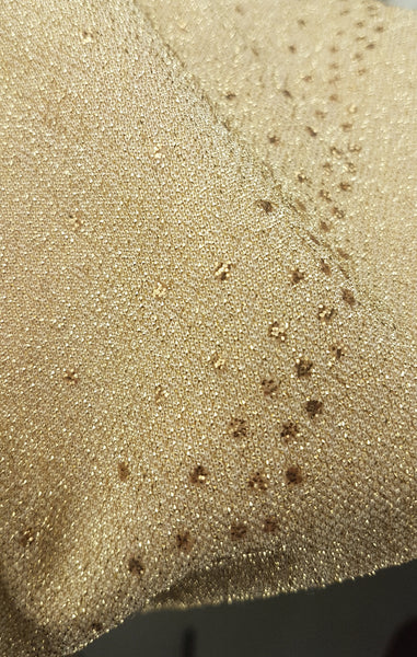 Detailed close-up of the shimmering gold lurex knit and metallic glitter-dot detailing on a vintage 1990s LA Glo dress.