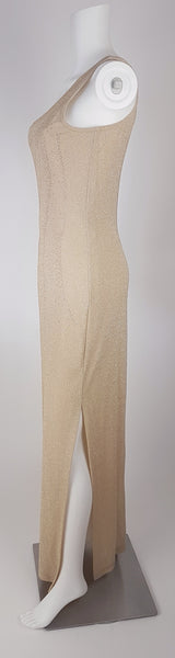 Full side view of a vintage 1990s LA Glo gold lurex evening gown, showing its one-shoulder neckline and high side slit.
