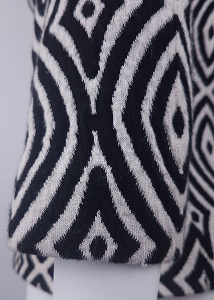 Close-up of the sleeve and sleeve hem on a vintage 1990s Le Château black-and-white patterned jacket.