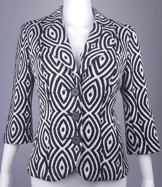 Full front view of a vintage 1990s Le Château black-and-white op-art jacket with notched lapels and a three-button closure displayed on a mannequin