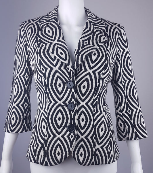 Full front view of a vintage 1990s Le Château black-and-white op-art jacket with notched lapels and a three-button closure displayed on a mannequin