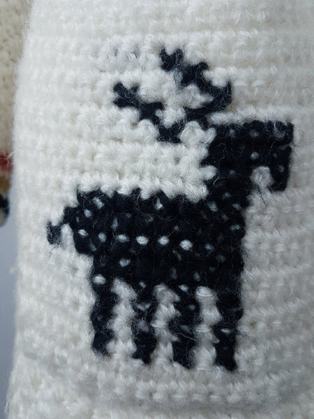 Closeup image of reindeer knit on a A vintage 1990's Leroy Knitwear cream cardigan sweater with deer motifs and wooden buttons, displayed on a mannequin.