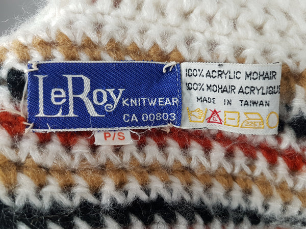 Label and care label for A vintage 1990's Leroy Knitwear cream cardigan sweater with deer motifs and wooden buttons, displayed on a mannequin.
