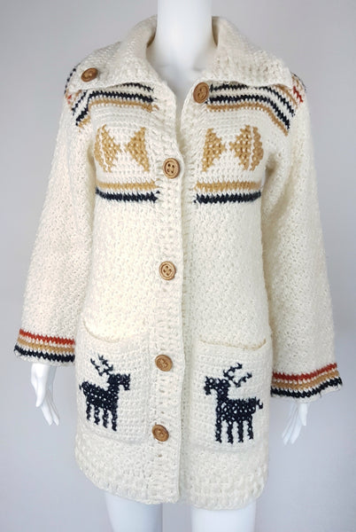 A vintage 1990's Leroy Knitwear cream cardigan sweater with deer motifs and wooden buttons, displayed on a mannequin.