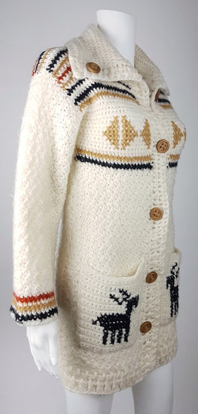 A vintage 1990's Leroy Knitwear cream cardigan sweater with deer motifs and wooden buttons, displayed on a mannequin.