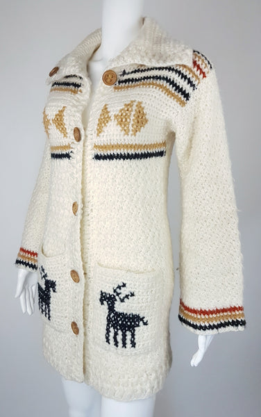 Closeup image of reindeer knit on a A vintage 1990's Leroy Knitwear cream cardigan sweater with deer motifs and wooden buttons, displayed on a mannequin.