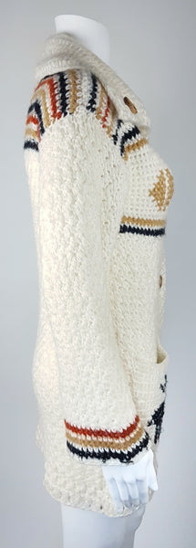 Side view of a vintage 1990's Leroy Knitwear cream cardigan sweater with deer motifs and wooden buttons, displayed on a mannequin.