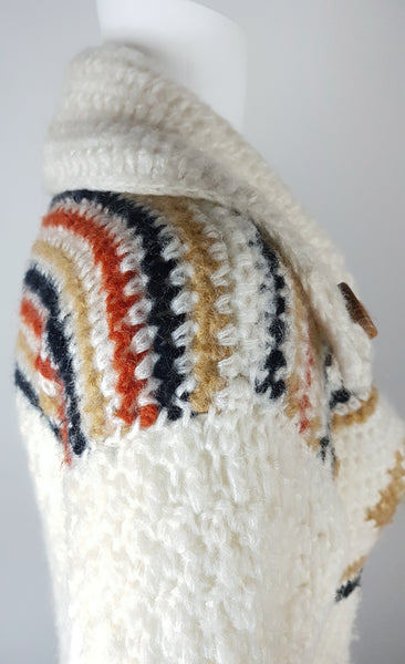 Shoulder view of a vintage 1990's Leroy Knitwear cream cardigan sweater with deer motifs and wooden buttons, displayed on a mannequin.