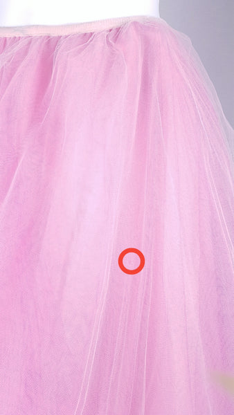 circled in red close-up view of the small hole in fabric on a vintage 1990s RALPH Ralph Lauren pink tulle maxi skirt with a voluminous layered A-line silhouette displayed on a mannequin