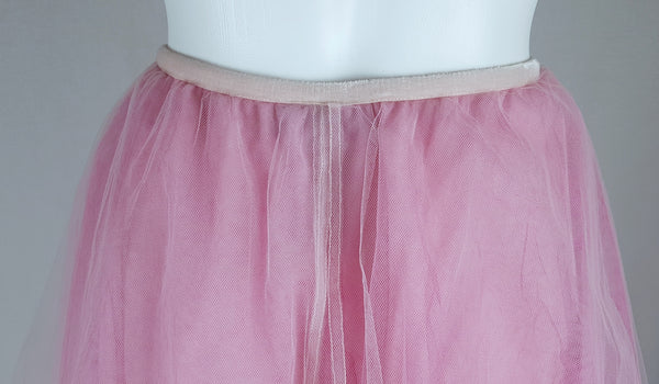 Close-up back view of the narrow elastic waistband and layered pink tulle on a vintage 1990s RALPH Ralph Lauren maxi skirt displayed on a mannequin