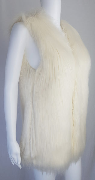 Full three quarter view of a cream long-pile faux-fur vest with a collarless neckline, decorative fastening and side pockets displayed on a mannequin